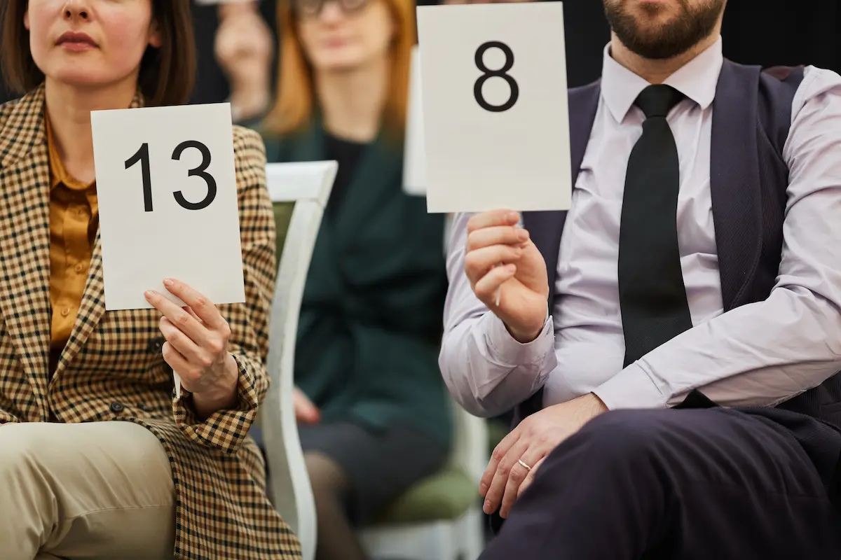 people put up auction numbers in bidding scenario
